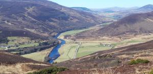 a view of a river in a mountain valley at Bannockburn Inn in Helmsdale