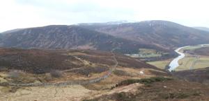 a view of a mountain with a river and a road at Bannockburn Inn in Helmsdale