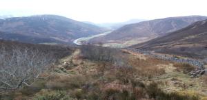 arial view of a mountain valley with a river at Bannockburn Inn in Helmsdale