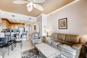a living room with a couch and a table at San Remo 406 in Santa Rosa Beach