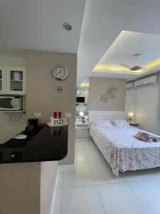 Un dormitorio con una cama y un reloj en la pared. en Apartamentos em Ipanema, en Río de Janeiro