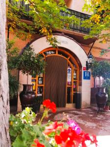 an entrance to a building with flowers in front of it at Hotel Suiza in Bronchales