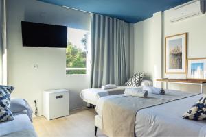 Ein Bett oder Betten in einem Zimmer der Unterkunft YOU & CO. Saler Beach Boutique