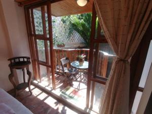 a room with a large glass window with a table and chairs at Casa Mamá Waldy Hostel in Cartagena de Indias