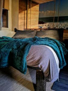 a bedroom with a bed with a blanket on it at appartment & rooms SecondoPiano in Cividale del Friuli