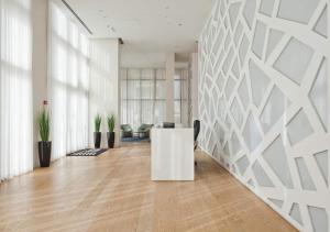 an office with a white wall and a desk at Oַ&O Group- Luxury APT Tower Spectacular Sea View in Bat Yam