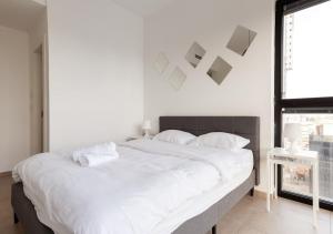a large white bed in a room with a window at Oַ&O Group- Luxury APT Tower Spectacular Sea View in Bat Yam +30 photos