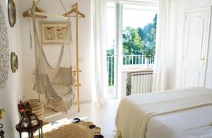 a bedroom with a bed and a hammock in it at Casa Maddy in Capri
