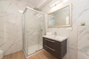 a bathroom with a shower and a sink and a mirror at Villa Eni apartments 2 in Mandre +47 photos