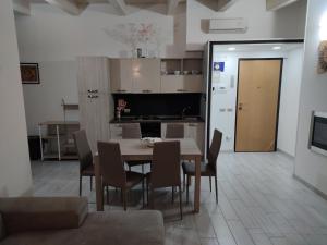 a kitchen and dining room with a table and chairs at Planet apartments 1 in Montalbano Jonico