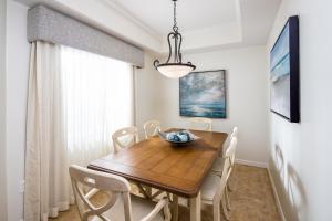 a dining room with a wooden table and chairs at Bellasera Resort in Naples
