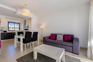 a living room with a couch and a table at One Bedroom Apartment in Albur Village 1A in Alvor