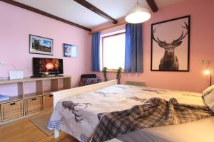 a bedroom with a bed and a deer on the wall at CHALET SCHWALBENNEST in Bad Kleinkirchheim