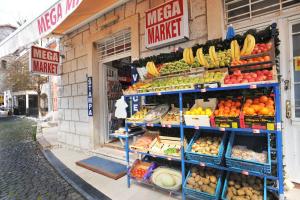 a grocery store with a display of fruits and vegetables at Apartments Jelena Skver in Herceg-Novi