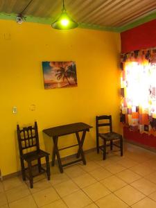 a dining room with a table and two chairs at Cabaña Quiahuiztlán Playa Villa Rica in Laguna Verde