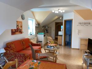 ein Wohnzimmer mit einem Sofa und einem Tisch in der Unterkunft Birnbaumhof - Hotel Pension und Ferienwohnungen in Schwedelbach