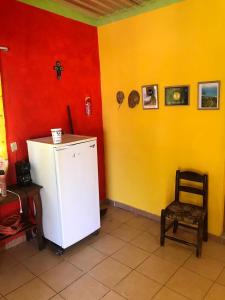 a room with a white refrigerator and a chair at Cabaña Quiahuiztlán Playa Villa Rica in Laguna Verde