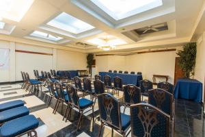 a room with a bunch of chairs and tables at Le Plaza Hotel in Port-au-Prince +41 photos