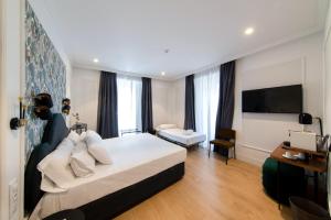 a hotel room with a bed and a television at Soho Boutique Opera in Madrid