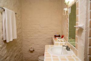 a bathroom with a sink and a toilet at Hotel Puerta Del Mar Ixtapa in Ixtapa