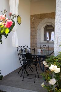 a patio with a table and chairs and flowers at Incanto in Budoni