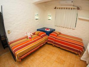 A bed or beds in a room at Hotel Puerta Del Mar Ixtapa