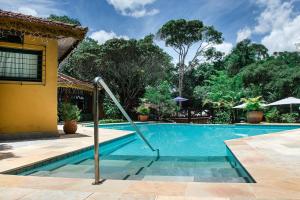 a swimming pool in front of a house at Urikana Boutique Hotel in Teresópolis