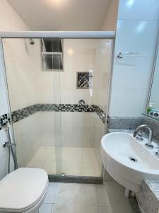 a bathroom with a shower and a toilet and a sink at Apartamentos em Ipanema in Rio de Janeiro