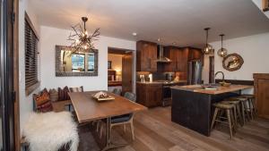 a kitchen with a table and a dining room at Relax in Luxury - Jacuzzi, Indoor/Outdoor Fireplace in Estes Park