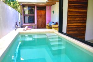 a swimming pool in the middle of a house at Villa Feronia Tulum in Tulum