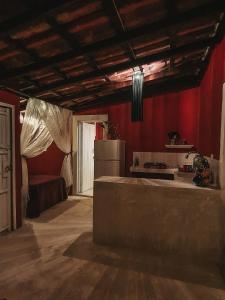 a kitchen with red walls and a refrigerator at Casa Awakening in El Cuyo