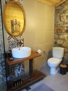 a bathroom with a sink and a toilet at Villa Haris in Sarti