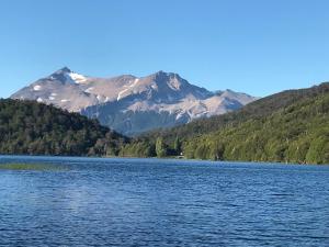 a view of a lake with mountains in the background at Cabaña Lago Largo in Coihaique