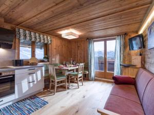 a kitchen and dining room with a table and a couch at Achrainer-Moosen in Hopfgarten im Brixental