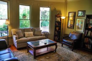 a living room with a couch and a coffee table at Beaufort House Inn in Asheville