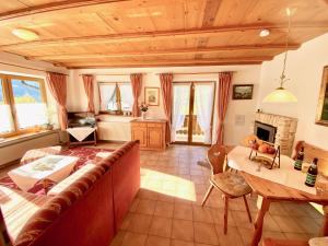 a living room with a large couch and a table at Berghof Punzenlehen - nahe Königssee in Bischofswiesen