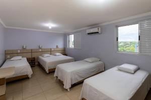 Postel nebo postele na pokoji v ubytování Hotel Baviera Iguassu