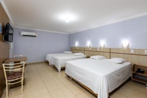 Postel nebo postele na pokoji v ubytování Hotel Baviera Iguassu