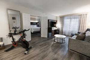 a living room with a bike and a room with a bed at EVEN Hotel Chicago - Tinley Park - Convention Center by IHG in Tinley Park