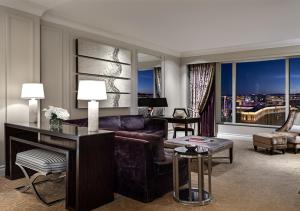 a living room filled with furniture and a large window at The Palazzo at The Venetian® in Las Vegas