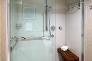 a bathroom with a shower with a glass door at Hyatt Place Chicago Wicker Park in Chicago