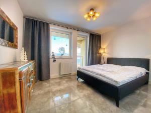 Posteľ alebo postele v izbe v ubytovaní Apartamenty Szóstka Wisła Kamienna