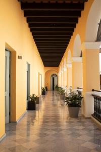 an empty hallway with potted plants in a building at Palacio Provincial - Adults Only in San Juan