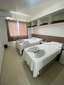 1 dormitorio con 2 camas y ventana. en Pousada Vó Dena, en Penha