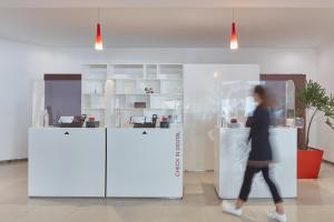 Eine Frau, die an einem Tresen vorbeigeht. in der Unterkunft Fiesta Inn Express Ciudad de México Forum Buenavista in Mexiko-Stadt