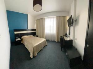 Postel nebo postele na pokoji v ubytování Hotel Real Rex