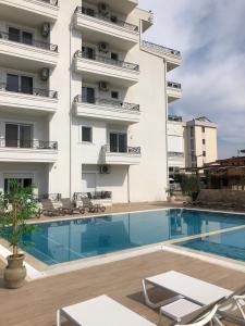 a hotel with a swimming pool in front of a building at METROPOLIS in Ulcinj