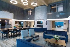 a lobby with blue furniture and a dining room at Best Western Plus Prince George in Prince George