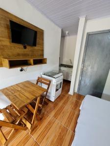 een woonkamer met een tafel en een fornuis. bij Residencial Primo in Capão da Canoa