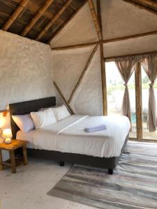 A bed or beds in a room at Cabalonga EcoAdventure
